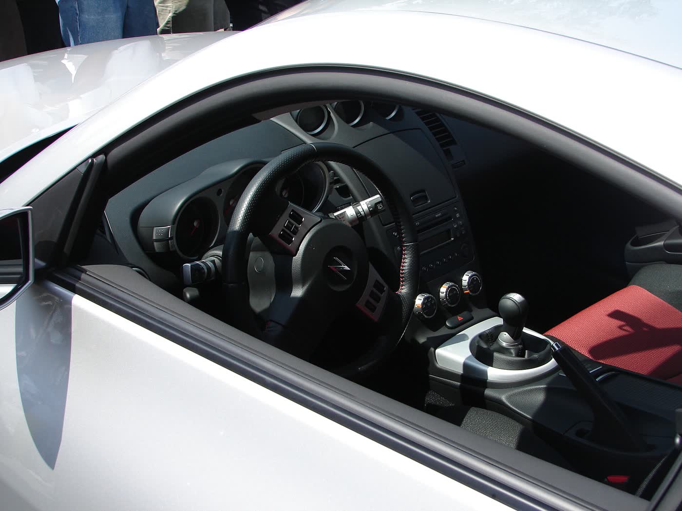 The cockpit of a Nismo Nissan 350Z, showing the gauges, shifter and seats