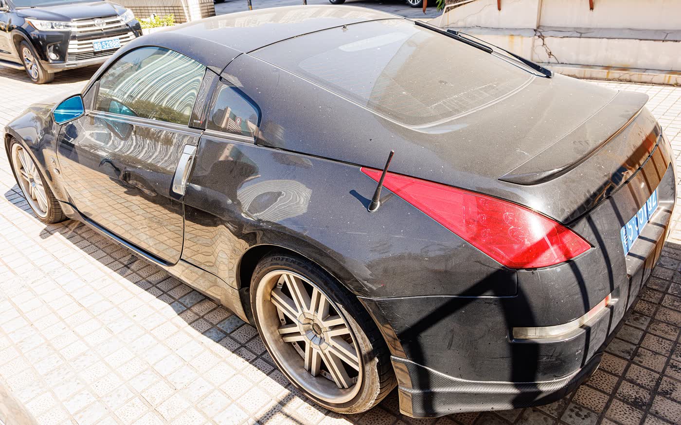 A black Nissan 350Z coupe seen from the rear three-quarter