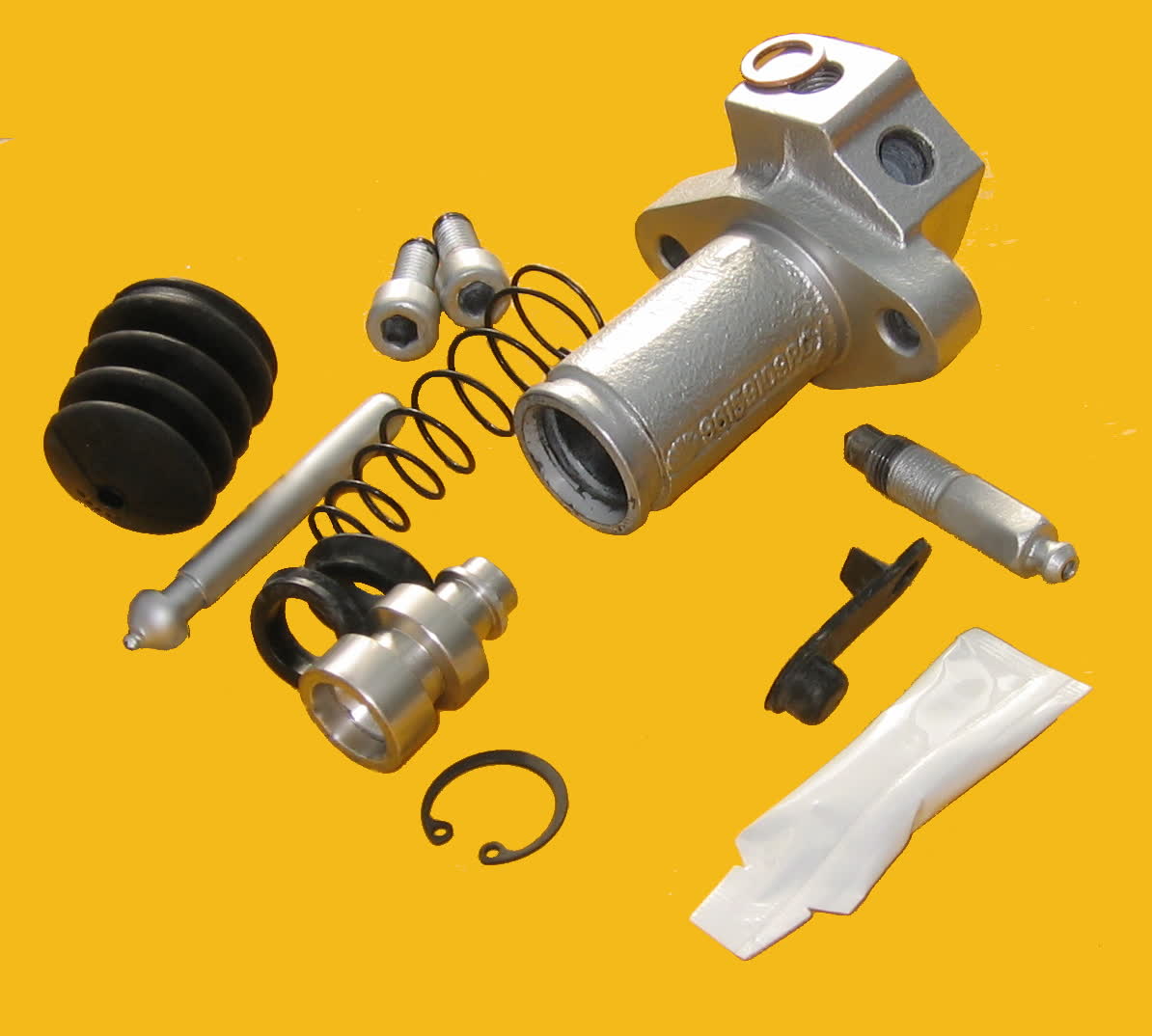 A clutch slave cylinder stripped into its component parts