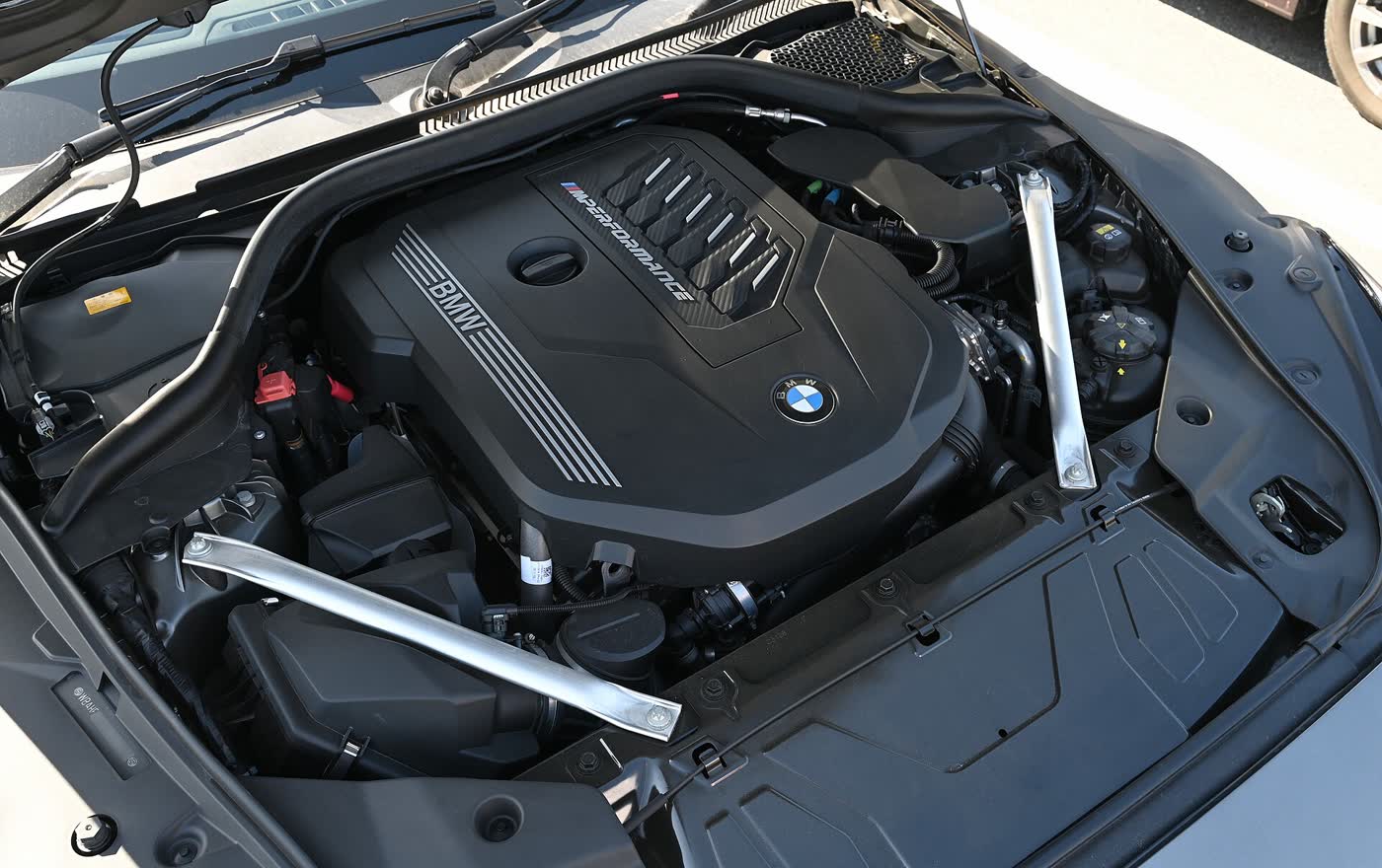 A BMW inline-six engine under its plastic cover in the engine bay of a Z4 M40i, seen from above