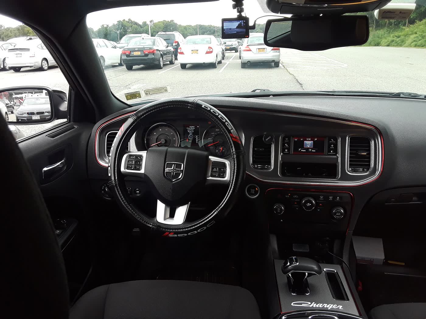 The dashboard of a 2013 Dodge Charger, showing the Uconnect touchscreen, gauges and automatic shifter