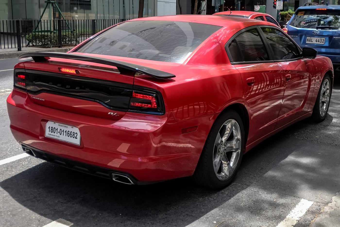 A red Dodge Charger R/T Max sedan with 5.7 Hemi badging, front three-quarter view