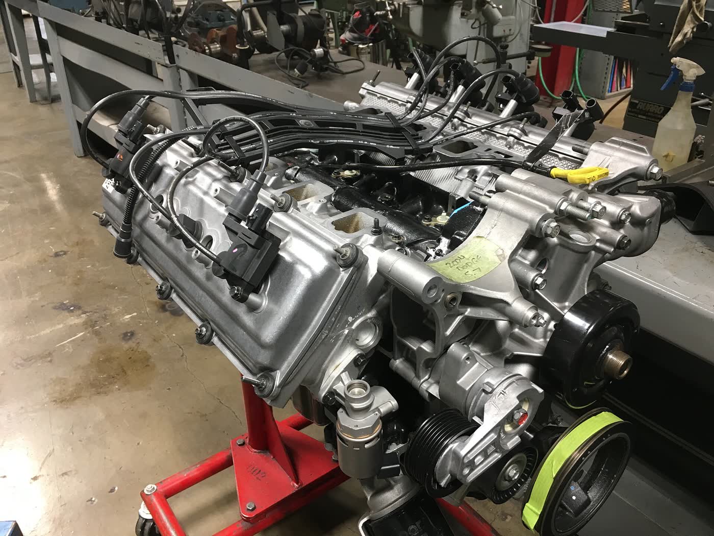 A Chrysler 5.7 Hemi V8 out of a Dodge, sitting on an engine stand in a workshop