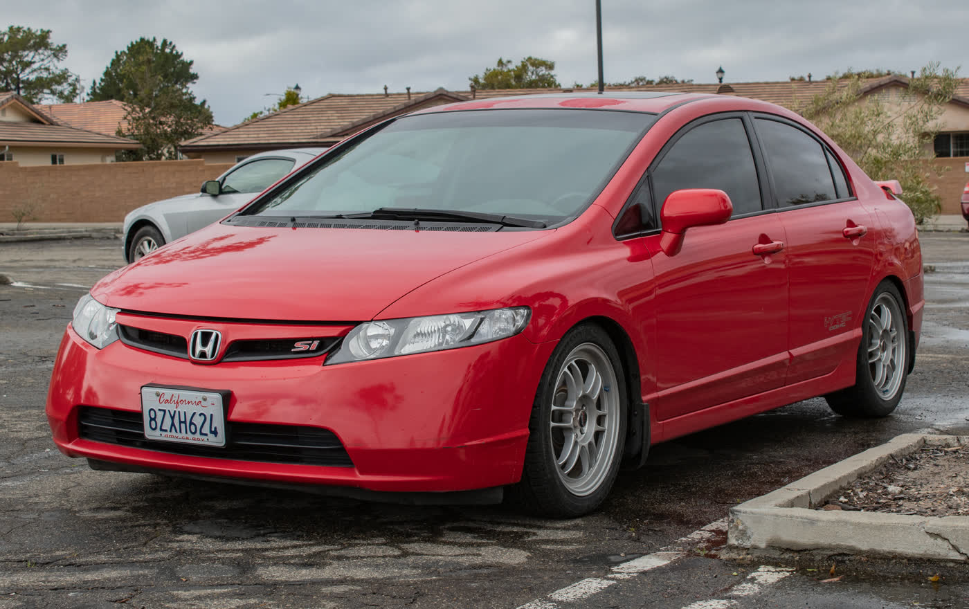 A red Honda Civic Si FA5 sedan, front three-quarter view