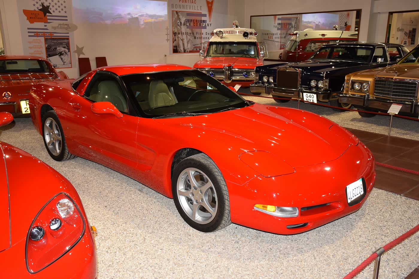 A red 2001 Chevrolet Corvette coupe on display indoors at a motor museum