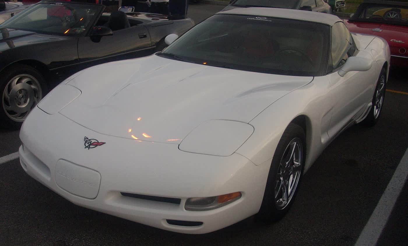 A modified Chevrolet Corvette C5 coupe with aftermarket wheels at a car show