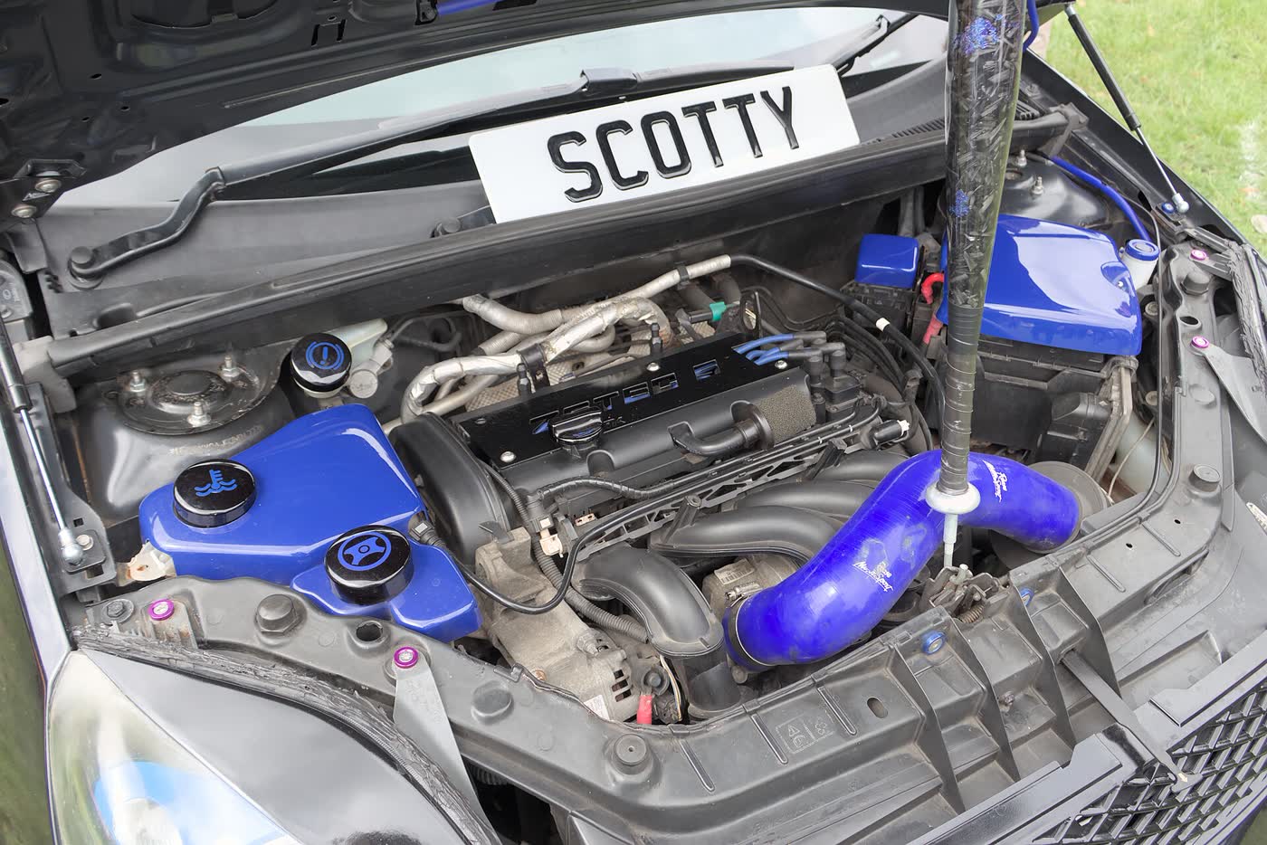 The engine bay of a Ford Fiesta ST with the bonnet raised, showing the 1.6 EcoBoost