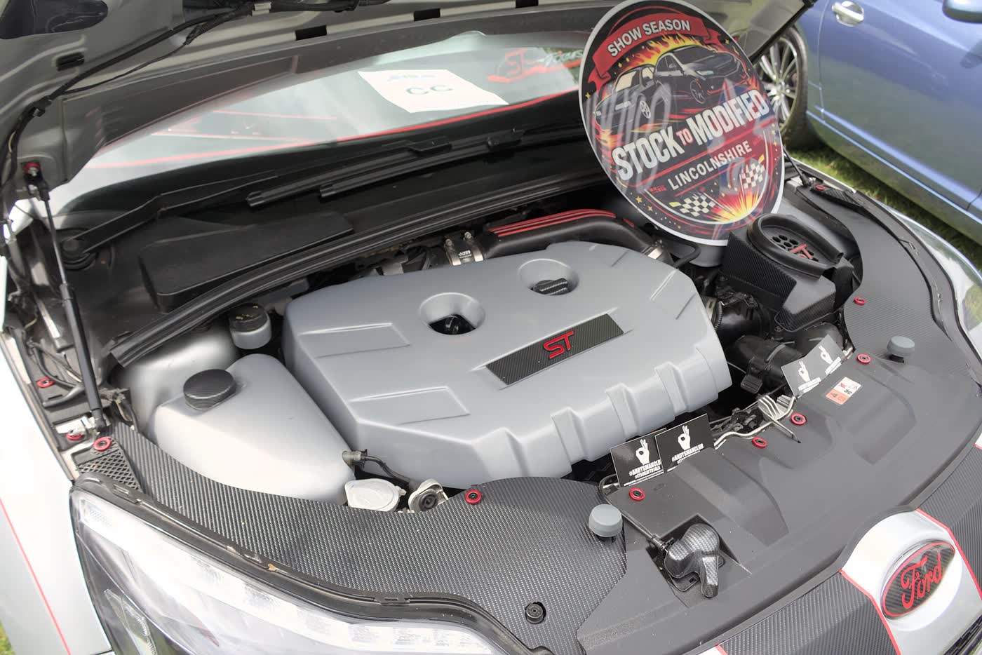 The engine bay of a Ford Focus ST with the bonnet raised, showing the 2.0 EcoBoost