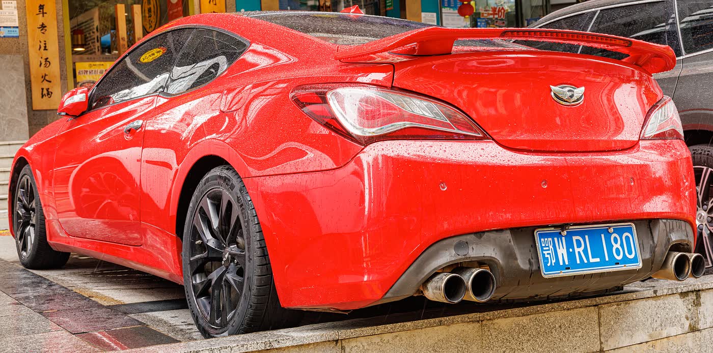 A red Hyundai Genesis Coupe facelift, front three-quarter view