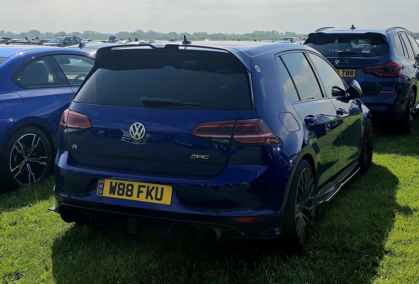 A blue Volkswagen Golf R Mk7 seen from the rear, showing the R badge and quad exhaust