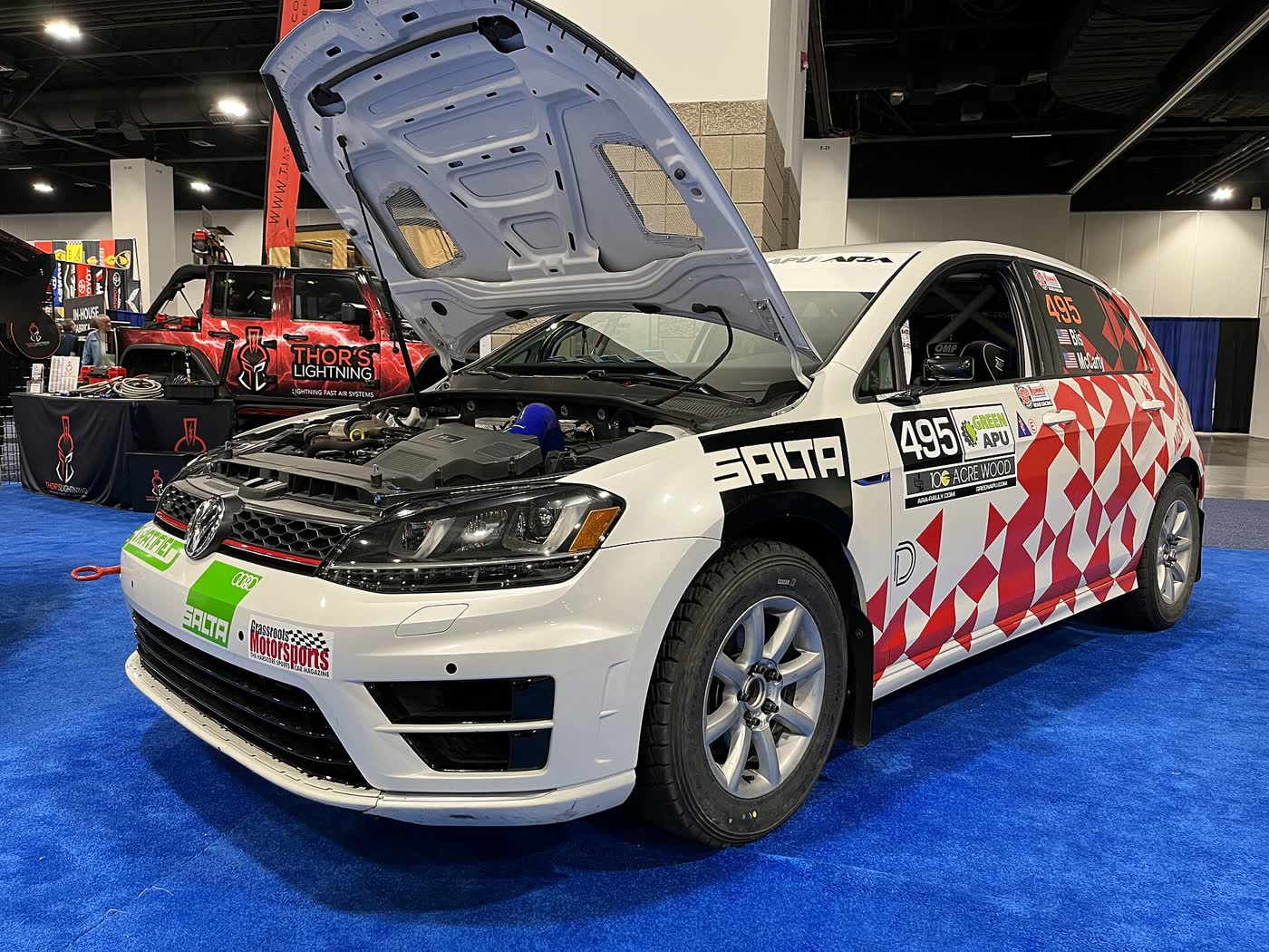 A Volkswagen Golf R Mk7 in rally livery with competition numbers on the door