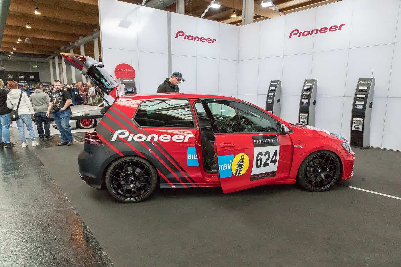 A modified Volkswagen Golf R on display at a tuning show