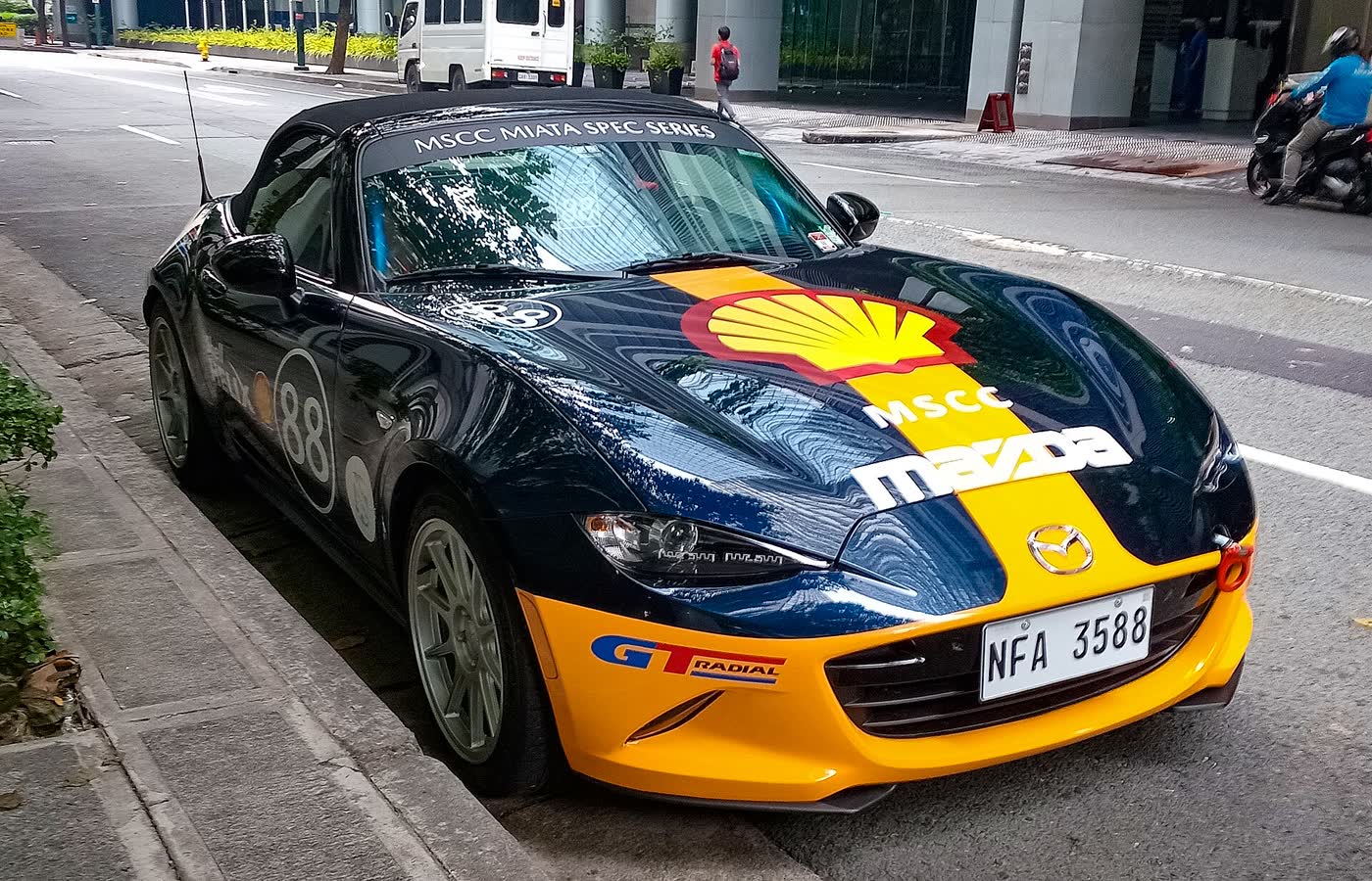 A Mazda MX-5 ND in Miata Spec Series race livery, number 88, with a front splitter and lightweight wheels