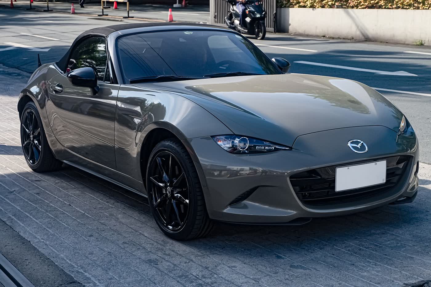 An Aero Gray Mazda MX-5 ND fitted with an AutoExe aero kit and black aftermarket wheels