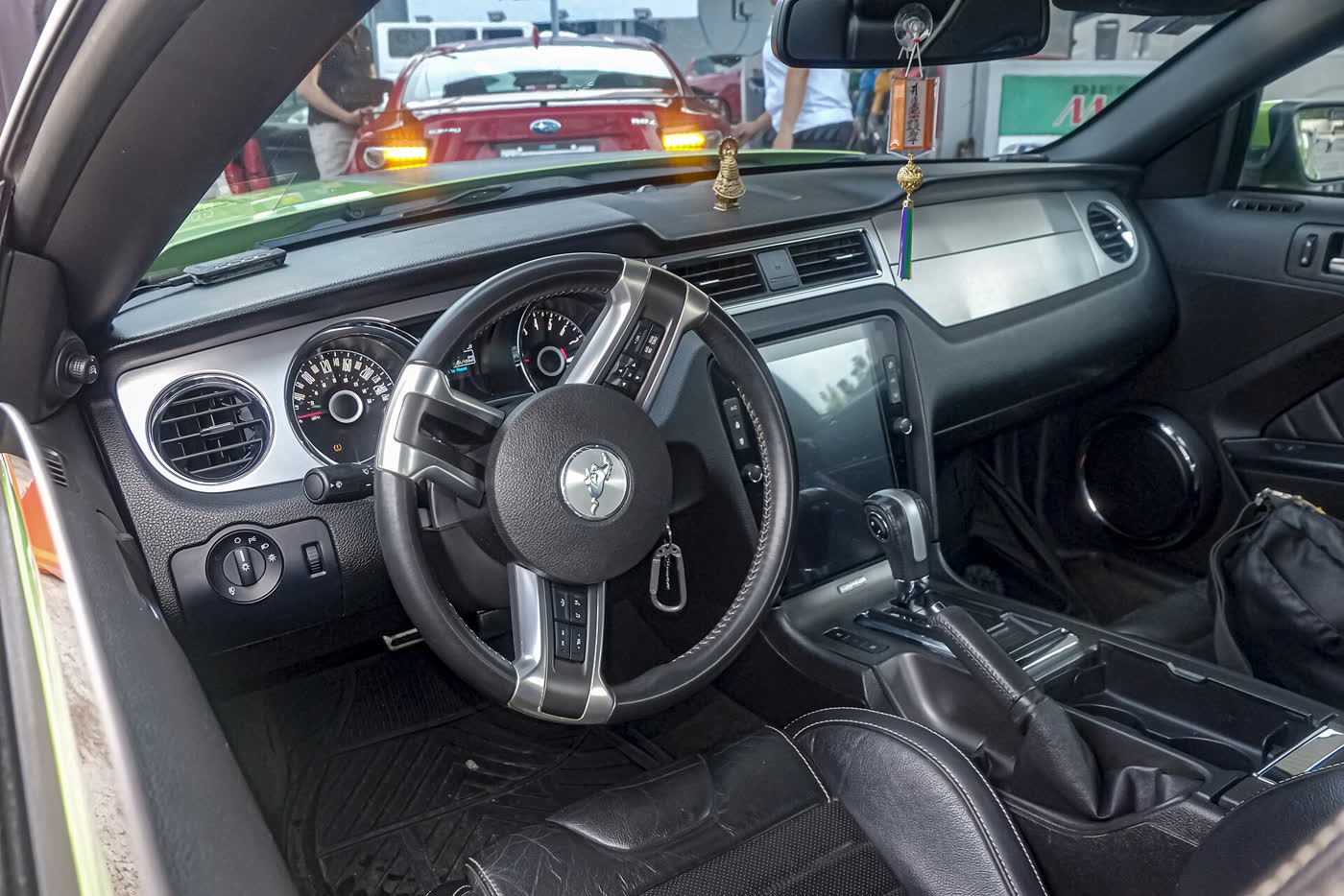 The dashboard of a facelift Ford Mustang S197 GT, showing the gauges, centre screen and console shifter