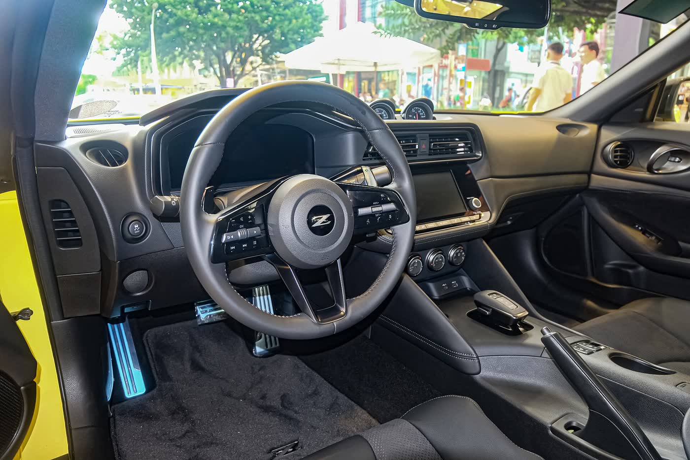 The interior of a Nissan Z RZ34 Premium, showing the dashboard, screen and the three pod gauges