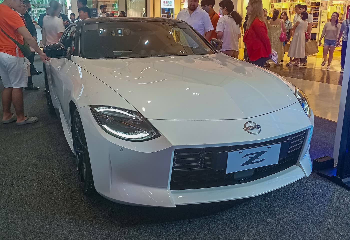 A white 2024 Nissan Z Premium on display indoors, front three-quarter view