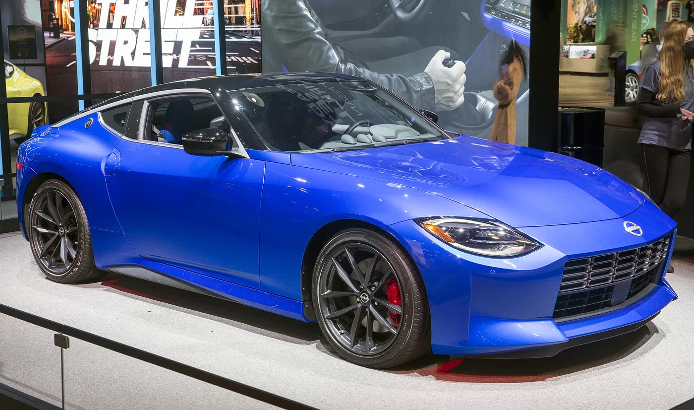 A blue 2023 Nissan Z Performance on a motor show stand, front three-quarter view