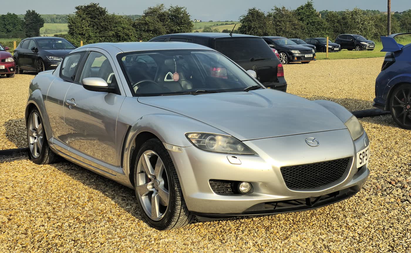 A Mazda RX-8 parked outdoors, three-quarter view
