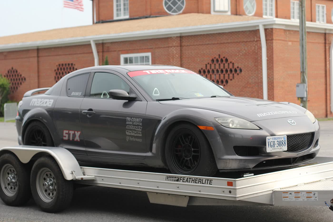A Mazda RX-8 on an autocross course with cones laid out around it