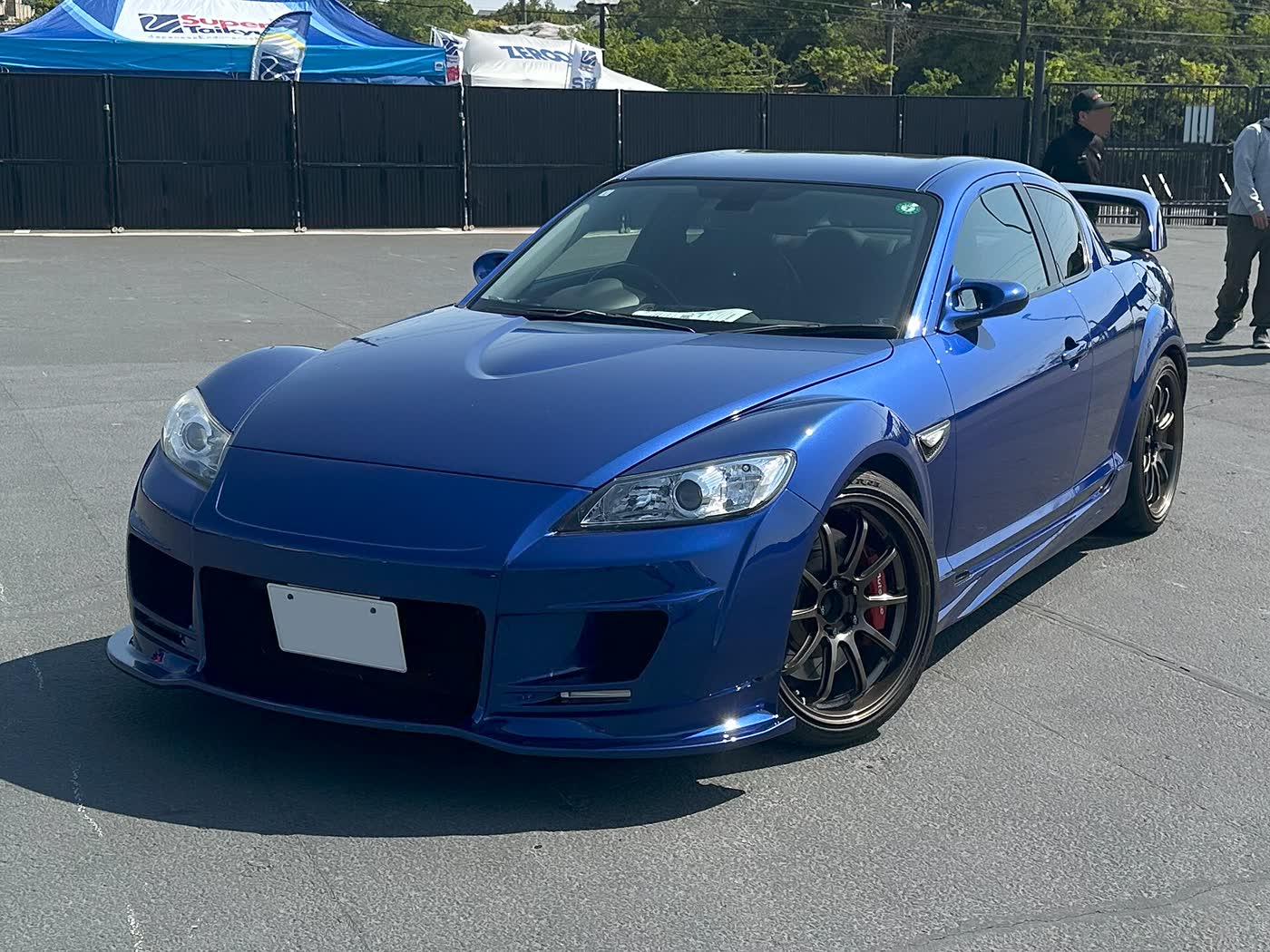A tuned Mazda RX-8 with aftermarket bodywork and wheels