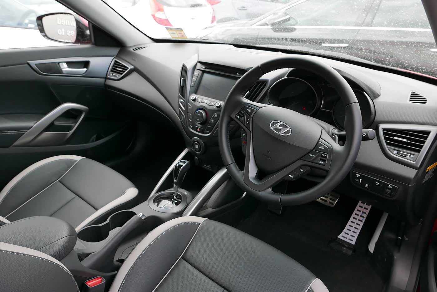 The interior of a Hyundai Veloster SR Turbo, showing the dashboard, centre stack and front seats